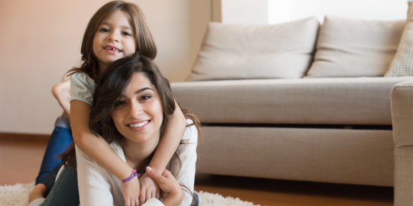 Mom and daughter smiling.