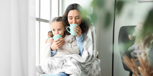 Mom and daughter drinking hot cocoa.