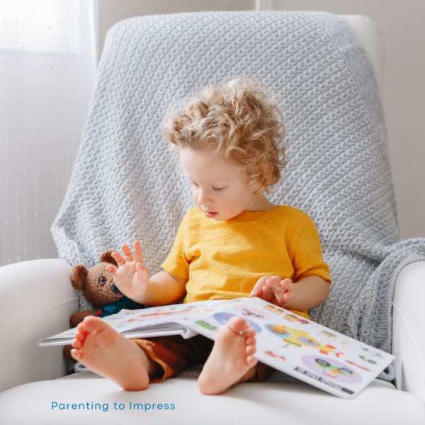 Young boy reading a picture book.