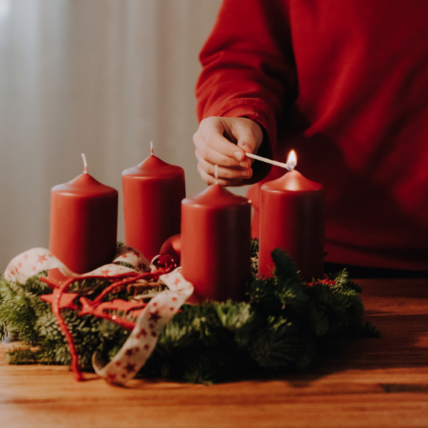 Child lighting Advent wreath.