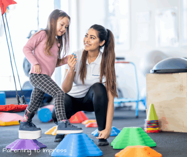 a little girl walking on a textured obstacle course with an OT"s help