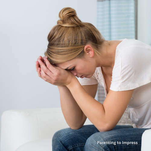 A stressed woman with her head in her hands.