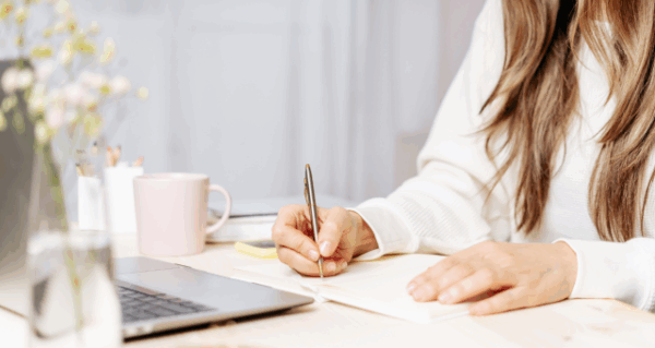 A woman looking at a laptop.