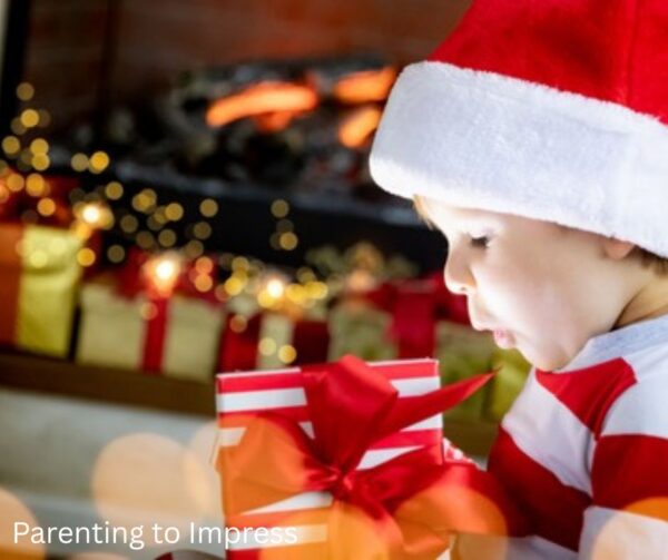 a toddler excitedly holding a Christmas gift