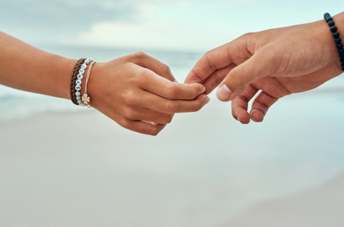 a parents hand letting go of a child's hand