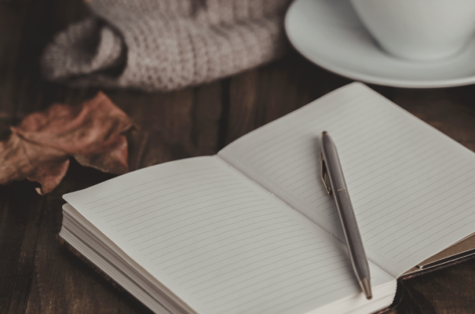 Journal with pen, coffee