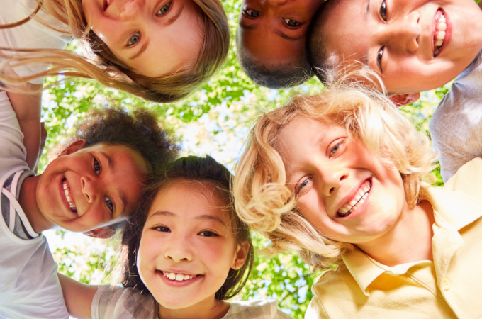 a circle of smiling confident kids