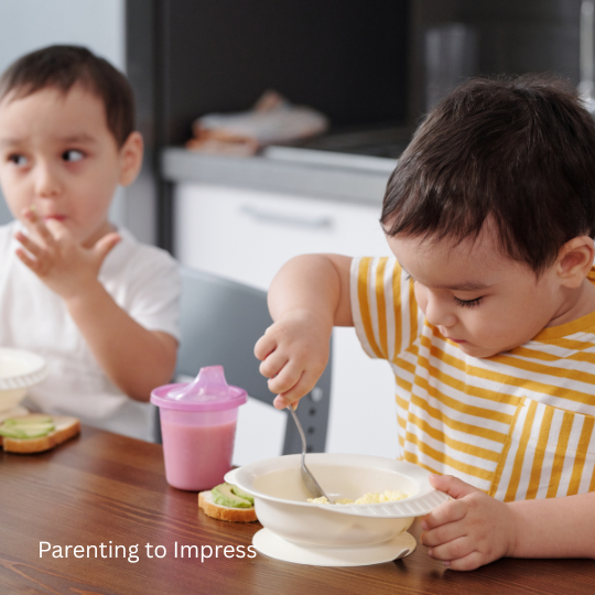 Boys sitting at a table and eating.