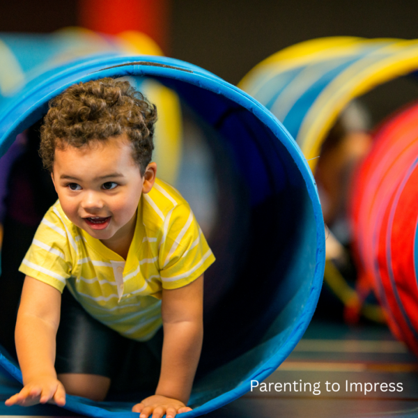 A boy crawling through a tunnel.