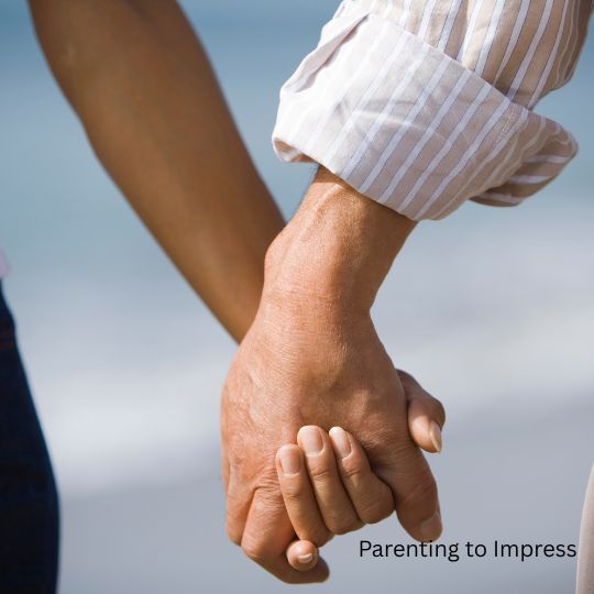 A married couple holding hands.
