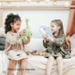 Two girls playing with stuffed animals, role playing.