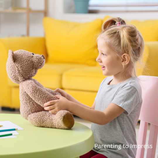 Girl with teddy bear, sitting at a table.